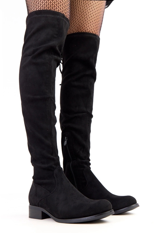 Botines largos negros de suela plana...