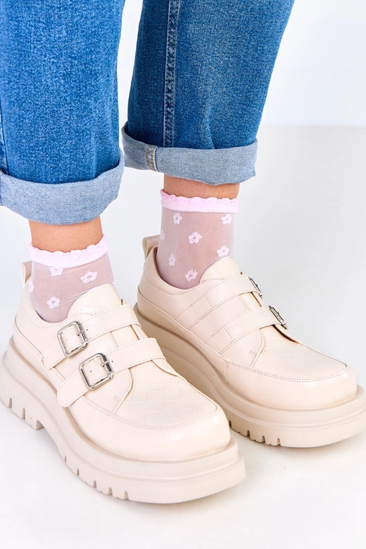 Botines color arena sobre suela...