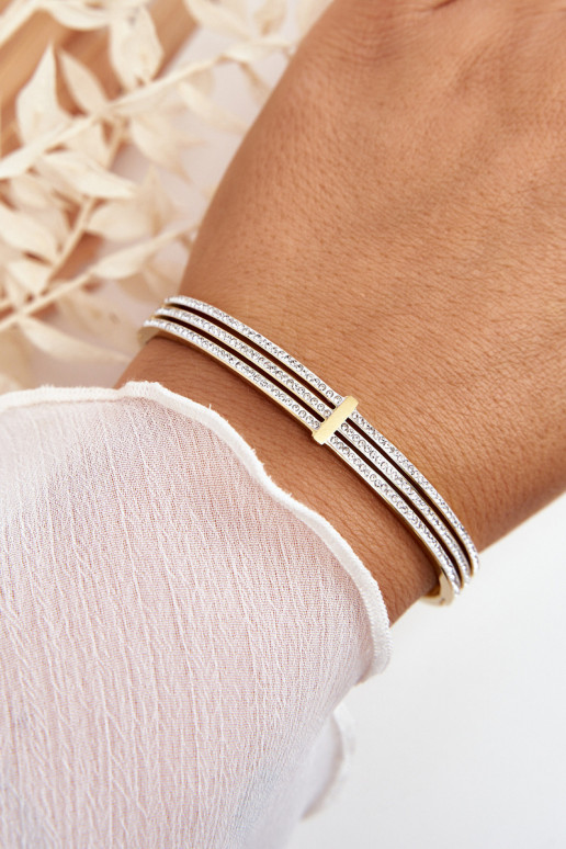 Una pulsera de acero inoxidable con ojos centelleantes color dorado