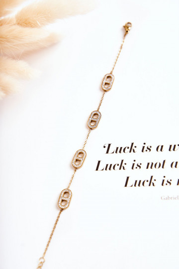 Pulsera de mujer con ojos brillantes en color dorado.