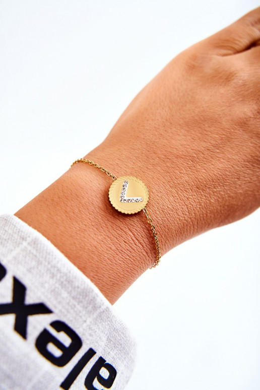 Pulsera de mujer con adornos y ojos de circonitas en color dorado.