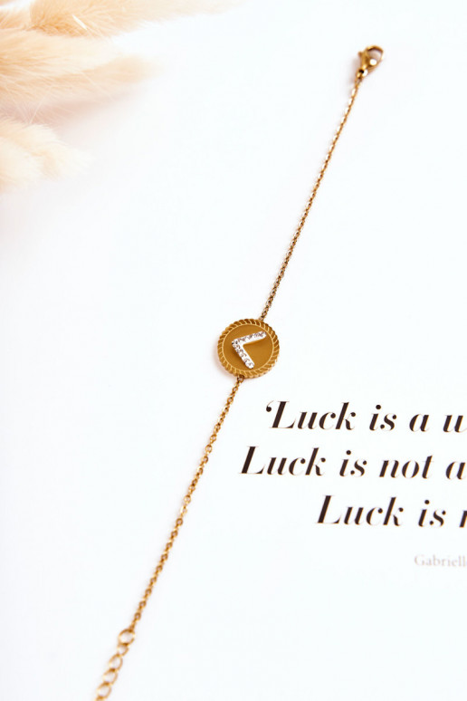 Pulsera de mujer con adornos y ojos de circonitas en color dorado.