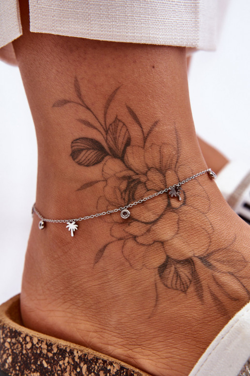 Pulsera de pierna plateada con ojos brillantes.